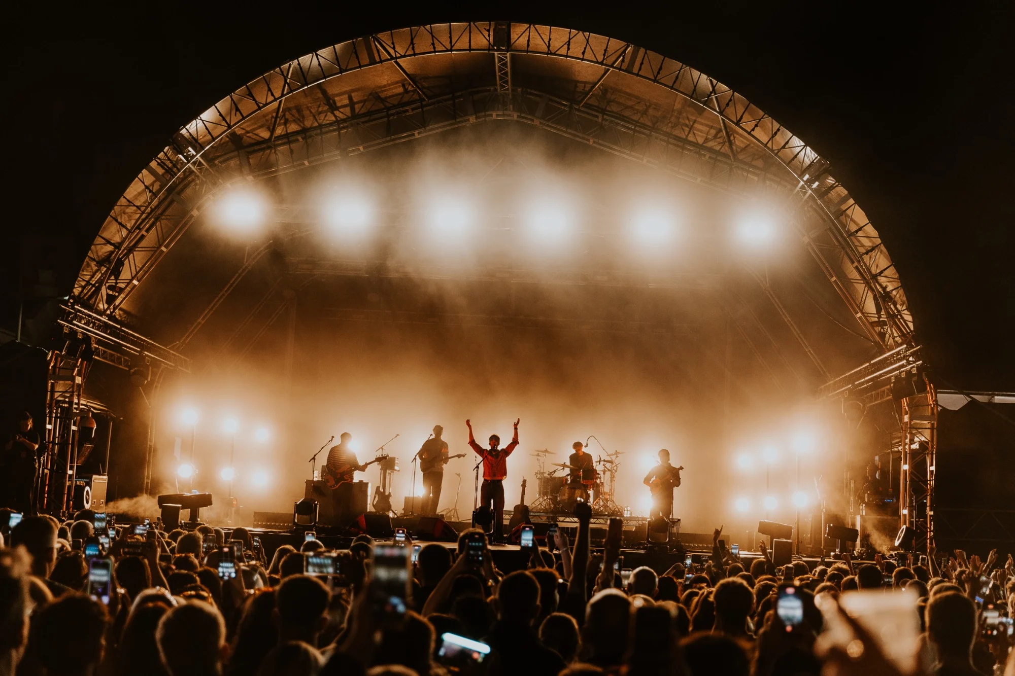 Kingfishr on stage beneath golden lights at Ebrington Square
